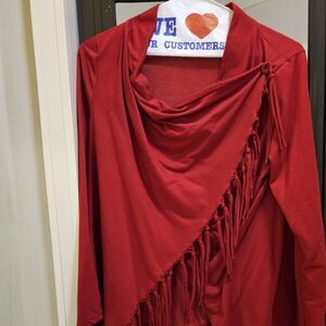 A reddish colored throw.